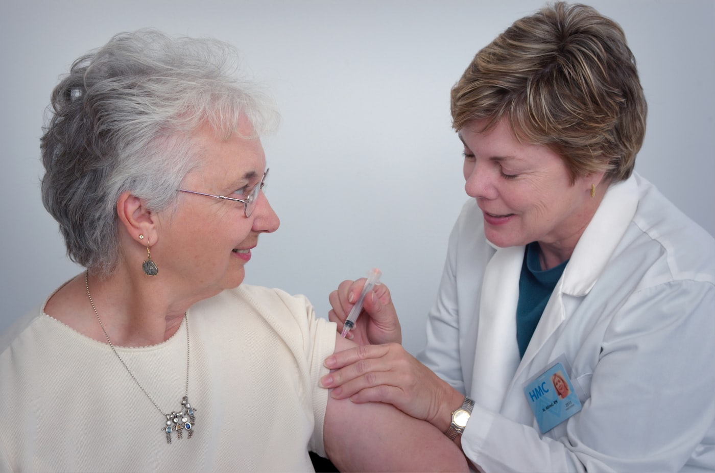 A nurse giving a patient a vaccination